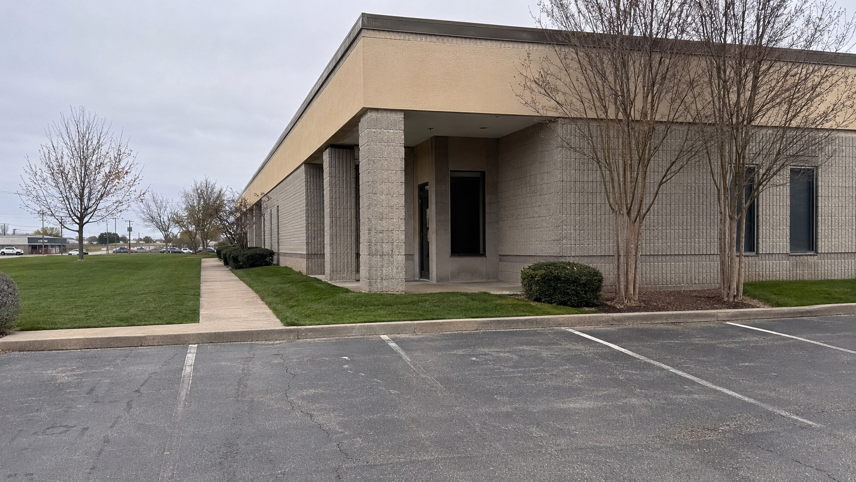 Commercial building with a mowed lawn along the sidewalk